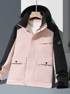 Outdoor hooded jacket with pink and black patchwork and mountain logo patch on sleeve