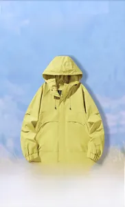 Detail of ginger yellow windproof jacket featuring high collar hood and utility pockets