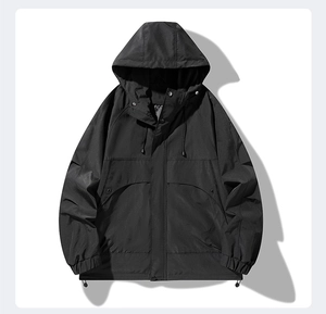 Detail view of black windproof jacket featuring adjustable drawstring hood and secure snap closure