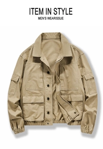 Close-up of khaki work jacket featuring multiple utility flap pockets and elastic hem design