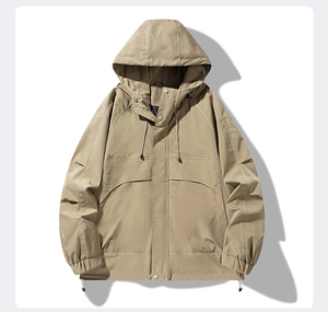 Detail of khaki outdoor hooded jacket with large cargo pockets and adjustable drawstrings