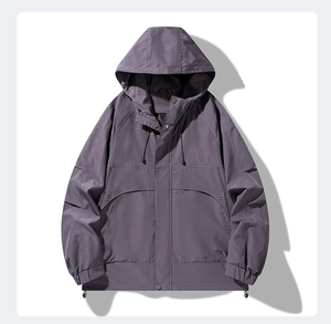 Detail view of grey hooded windbreaker with drawstring hood and large flap pockets