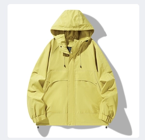 Close-up of bright yellow hooded jacket with windproof drawstrings and double placket detail