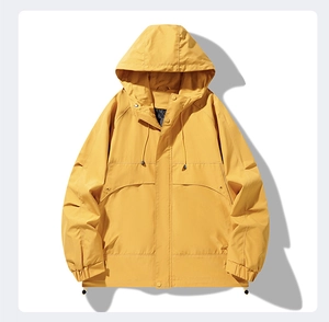 Detailed macro view of yellow hooded windbreaker featuring drawstring and snap buttons