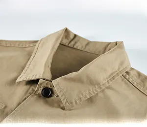 Detailed close-up of khaki utility jacket square collar and button on twill fabric