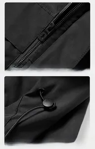 Close-up detail of smooth zipper and adjustable drawstring hood on black outdoor jacket