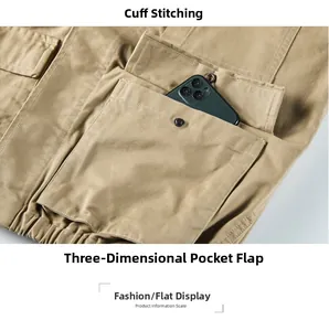 Close-up of khaki work jacket featuring a large utility pocket with metal snap button