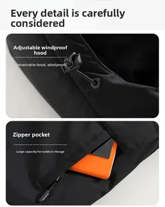 Detail of adjustable windproof hood and large zipper pocket on black outdoor jacket