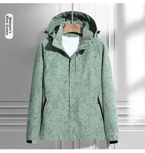 Close-up of women's hooded outdoor jacket in pea green with tropical leaf print detail
