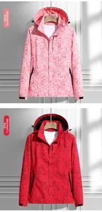 Detail view of women's windproof jacket with maple leaf pattern in pink and red colors