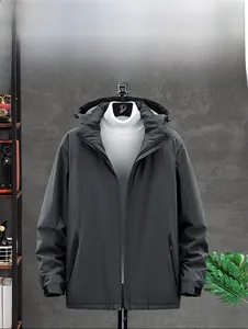 Detail of windproof and breathable dark gray hooded jacket with functional labels