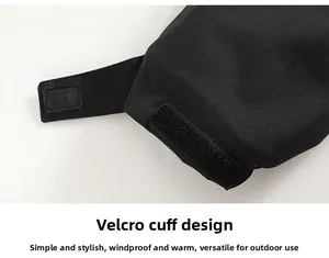 Detailed close-up of adjustable Velcro cuff on a black waterproof outdoor winter jacket