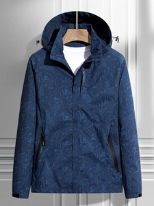 Water-resistant dark blue windbreaker with palm leaf print and Explore lettering