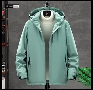 Detail of mint green waterproof jacket featuring vertical EXPLORE print and adjustable cuffs