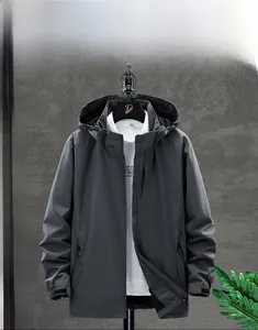 Detailed view of dark grey waterproof windbreaker jacket with hooded design and front zipper