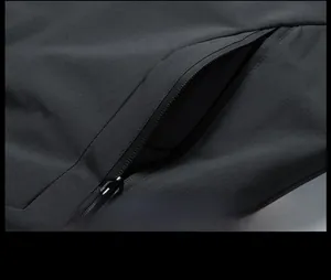 Detail view of a black outdoor jacket showing a secure zippered side pocket design