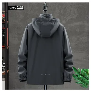 Rear view of dark grey waterproof outdoor jacket with reflective dots on hem