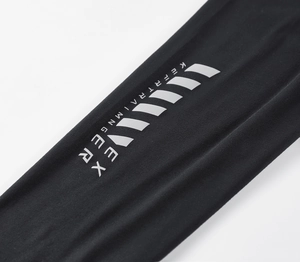 Detailed close-up of quick-dry men's sports pants featuring white Keep Training print