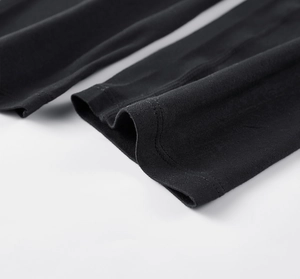 Detail view of double-needle stitching on black elastic quick-dry athletic pants fabric