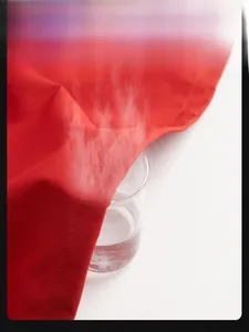 Close-up of red waterproof fabric showing windproof and breathable properties for jackets