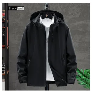 Front view of a black hooded functional outdoor jacket with zipper and chest detail