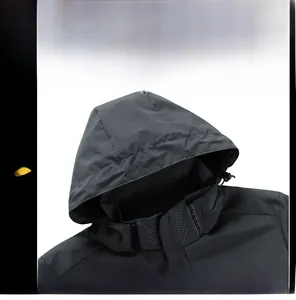 Detail view of the deep gray jacket hood with laser-cut breathability holes