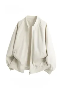 Detail view of the cream white baseball jacket showing ribbed collar and smooth fabric texture