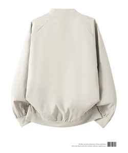 Back view of a beige minimalist bomber jacket with raglan sleeves and ribbed cuffs