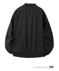 Back view of black baseball jacket with white starry splatter pattern and ribbed cuffs