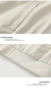 Detail view of the ribbed hem and pocket design on a beige baseball jacket