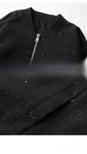 Detail of ribbed baseball collar with metal zipper and slanted pockets on black jacket