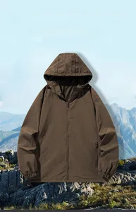 Detail view of water-resistant pockets and elastic cuffs on a brown outdoor jacket