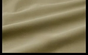 Detailed macro view showing the high-quality khaki woven fabric texture of the men's jacket