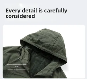 Detail of army green sun protection jacket with wide brim hood and black mesh lining