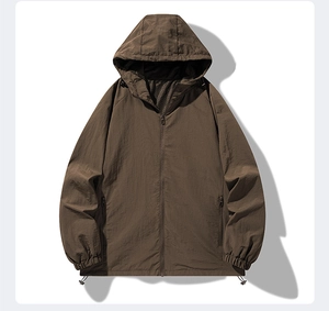 Detail of dark brown outdoor jacket showing breathable mesh lining and adjustable hem