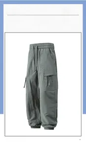 Detail view of grey cargo joggers featuring drawstring waist and large side pocket design