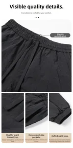Detail view of black cargo joggers showing elastic drawstring waist and side pocket texture