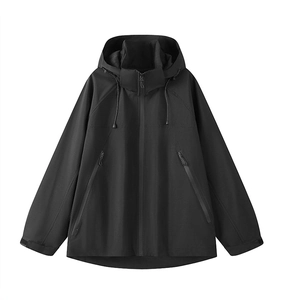 Detail of adjustable Velcro cuffs and functional zippers on black windproof outdoor jacket