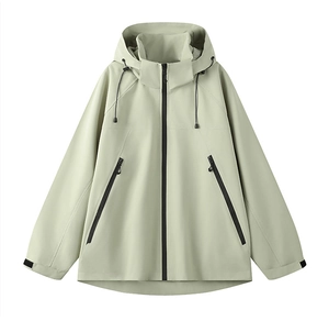 Detail of light green waterproof jacket featuring contrast zippers and adjustable cuffs