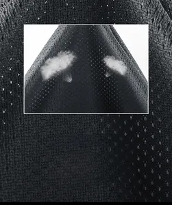 Macro detail of the breathable mesh lining on men's jacket showing steam ventilation