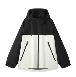 Detail view of water-resistant hooded jacket with color-block design and adjustable cuffs