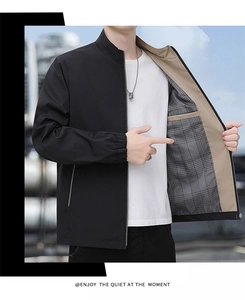 Detail of black stand collar jacket featuring classic plaid lining and inner pocket