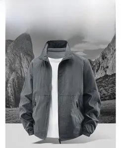 Detail shot of men's dark gray windbreaker jacket with stand collar and zipped pocket