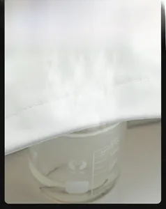 Close-up of white outdoor jacket fabric showing high breathability with steam demonstration