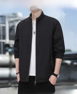 Detail of black stand collar jacket with metal zipper and elastic cuffs for men