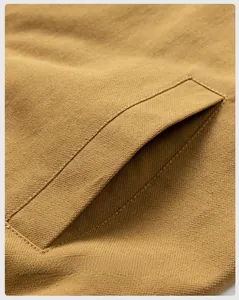 Detail view of khaki jacket large pocket showing durable woven fabric and stitching