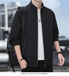 Detail of men's black stand-collar jacket featuring a metal zipper and side pockets