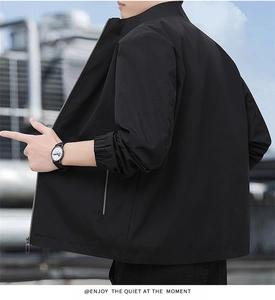 Close-up of minimalist black casual jacket featuring stand collar and metal zipper detail