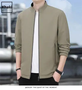 Detail view of khaki jacket showing stand collar zip closure and elastic cuffs on model