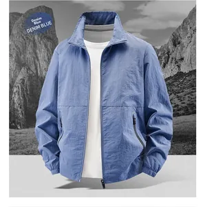 Detailed macro view of denim blue lightweight outdoor jacket with zip pockets and stand collar